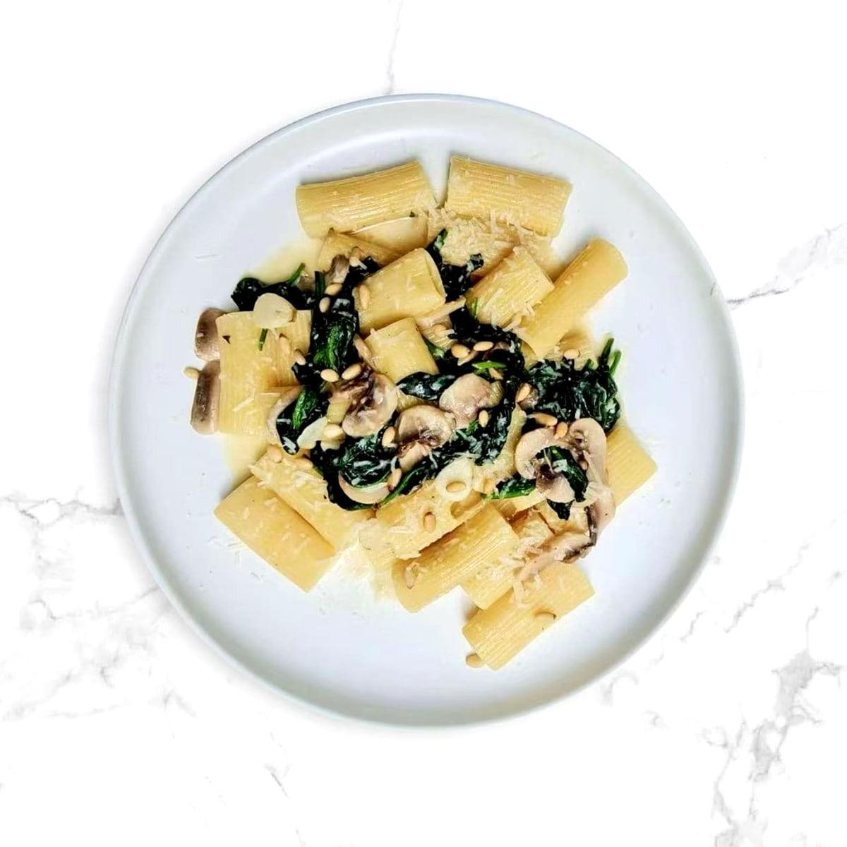 Rigatoni with greens, mushrooms, and pine nuts at Justgrapes